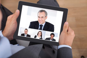 Businessman Video Conferencing With Coworkers On Digital Tablet